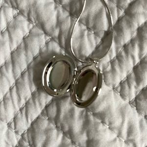 Locket and chain. You can put in your picture on both sides.